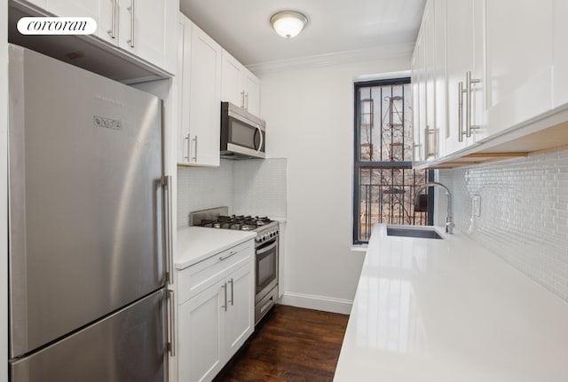 24-65 38th St Unit A5, New York City, NY 11103 - kitchen with stainless steel appliances, a sink, crown molding, decorative backsplash, and light countertops