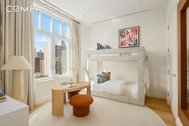 15 W 96th St Unit 18, New York City, NY 10025 - bedroom featuring light wood-style floors, baseboards, and a city view