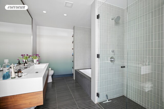 438 E 12th St Unit 6C, New York City, NY 10009 - bathroom featuring a tile shower, tile patterned floors, a tub, vanity, and toilet