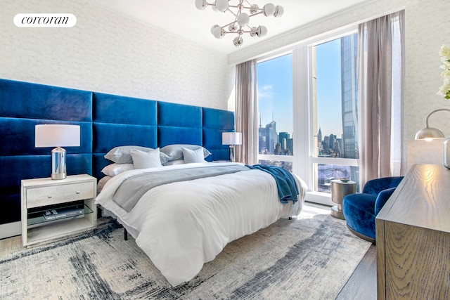 35 Hudson Yards Unit 5504, New York City, NY 10001 - bedroom featuring a chandelier, wood finished floors, and a skyline view