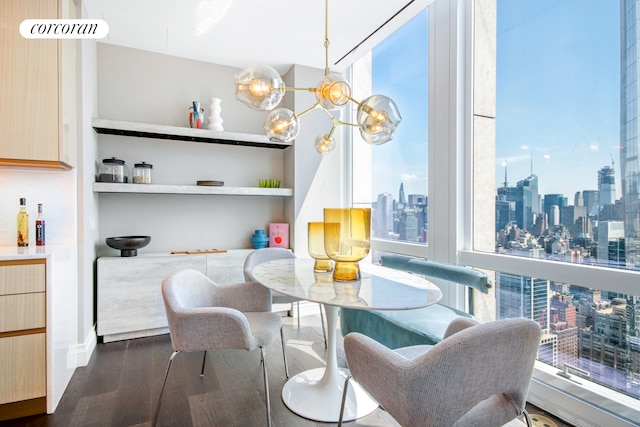 35 Hudson Yards Unit 5504, New York City, NY 10001 - dining room featuring a view of skyline, dark wood-style flooring, healthy amount of natural light, and a chandelier