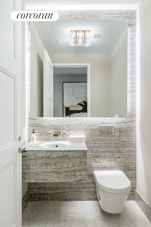 35 Hudson Yards Unit 5504, New York City, NY 10001 - bathroom with toilet, tile walls, vanity, and tile patterned flooring