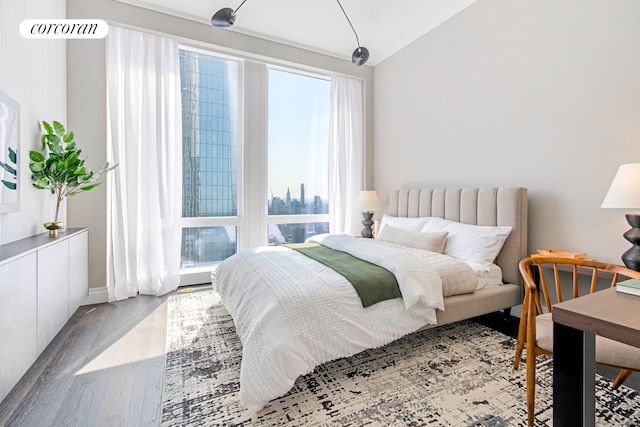 35 Hudson Yards Unit 5504, New York City, NY 10001 - bedroom with lofted ceiling, wood finished floors, and baseboards