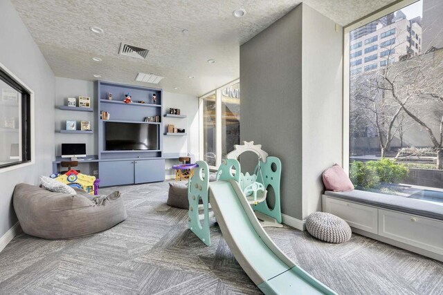 845 United Nations Plz Unit 7-H, New York City, NY 10017 - recreation room featuring carpet flooring and a textured ceiling