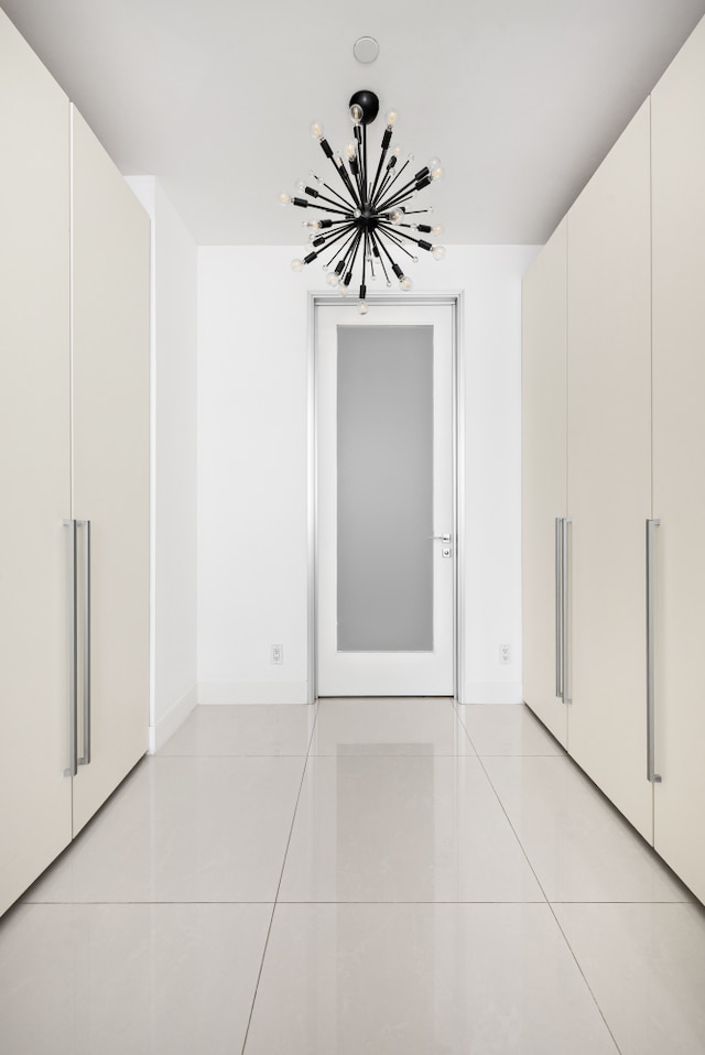 111 Fulton St Unit 318, New York City, NY 10038 - empty room featuring light tile patterned floors and a chandelier