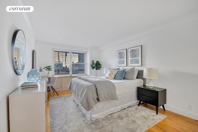 bedroom featuring crown molding, visible vents, and light wood-style floors