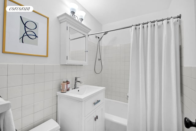 full bathroom featuring shower / bathtub combination with curtain, vanity, and tile walls
