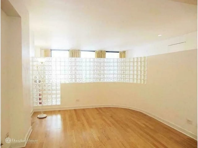 56 Pine St Unit 8G, New York City, NY 10005 - unfurnished room featuring wood finished floors and baseboards