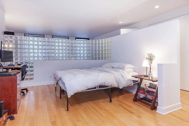 bedroom with recessed lighting and wood finished floors