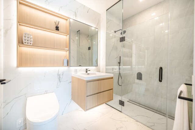 37-34 33rd St Unit 3-K, New York City, NY 11101 - bathroom with a marble finish shower, vanity, marble finish floors, and toilet