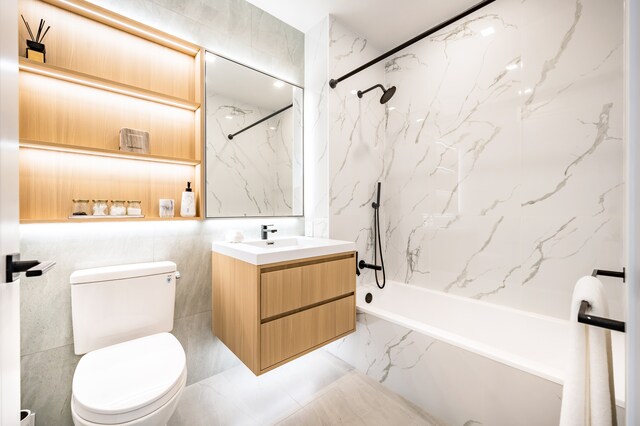 37-34 33rd St Unit 3-K, New York City, NY 11101 - bathroom with toilet, vanity, and a combined bath / shower with marble appearance