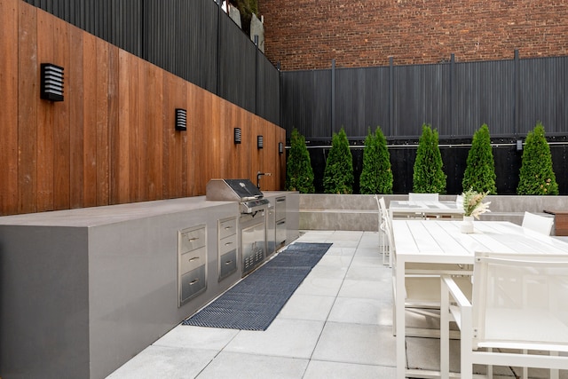37-34 33rd St Unit 2-B, New York City, NY 11101 - view of patio / terrace featuring an outdoor kitchen, fence, and a grill