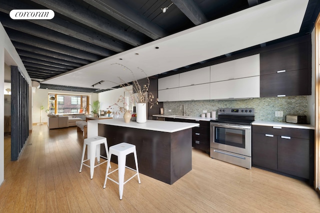 126 2nd St, New York City, NY 11231 - kitchen with a sink, light countertops, modern cabinets, and stainless steel range with electric stovetop