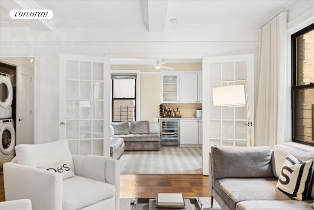 545 W End Ave Unit 7Ef, New York City, NY 10024 - living room with stacked washer and dryer, crown molding, wood finished floors, beverage cooler, and indoor bar