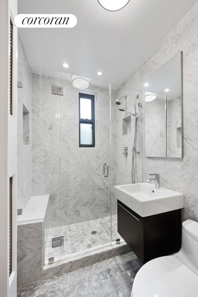 545 W End Ave Unit 7Ef, New York City, NY 10024 - bathroom featuring vanity, toilet, tile walls, recessed lighting, and a marble finish shower