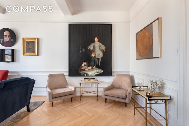 65 E 96th St Unit 15D, New York City, NY 10128 - living area featuring ornamental molding, wainscoting, and a decorative wall