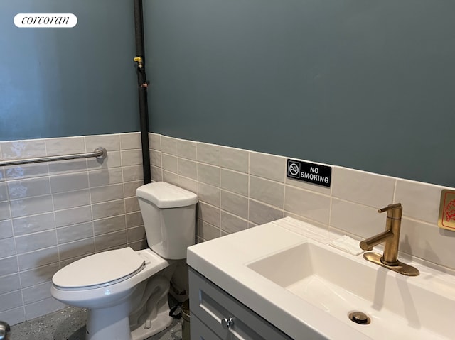 550 Metropolitan Avenue Commercial, New York City, NY 11211 - half bath with tile walls, toilet, vanity, and a wainscoted wall