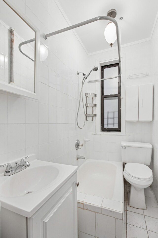 137 W 142nd St Unit 3A, New York City, NY 10030 - bathroom featuring crown molding, vanity, toilet, tile walls, and shower / bathing tub combination