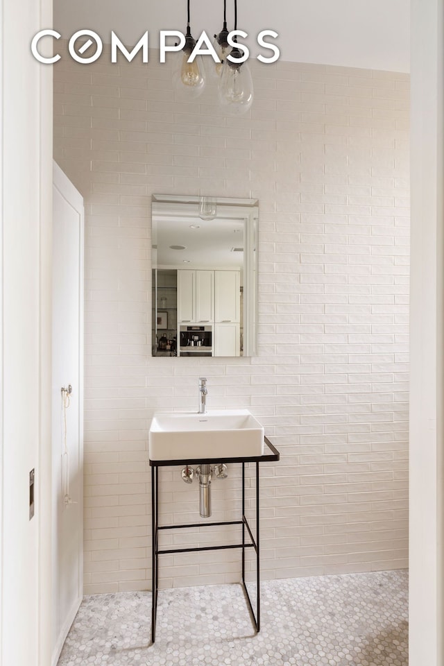 180 E 79th St Unit 14G, New York City, NY 10075 - bathroom with a sink and a chandelier