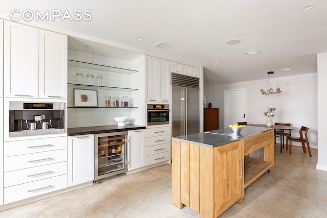 180 E 79th St Unit 14G, New York City, NY 10075 - indoor dry bar with beverage cooler, appliances with stainless steel finishes, and decorative light fixtures
