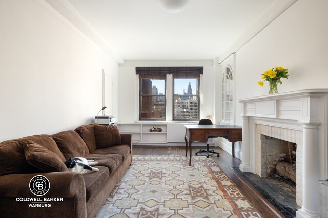 170 E 79th St Unit 9/10B, New York City, NY 10075 - living room featuring wood finished floors and a fireplace