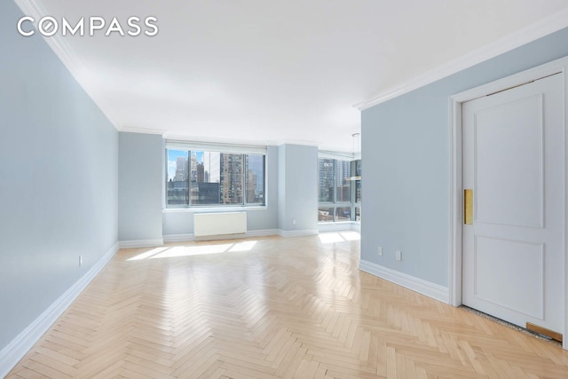 spare room with baseboards and ornamental molding