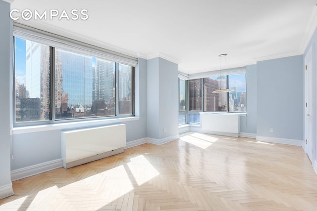 unfurnished room featuring baseboards and crown molding