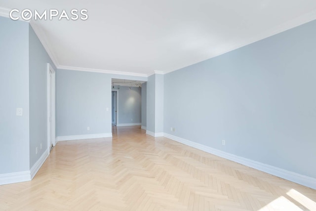 unfurnished room with baseboards and crown molding