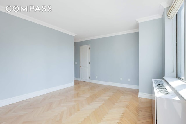 empty room with baseboards, visible vents, and ornamental molding