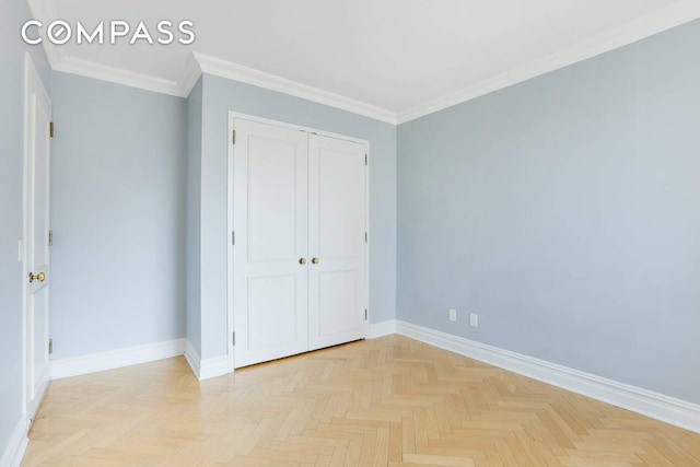 unfurnished bedroom featuring baseboards, ornamental molding, and a closet