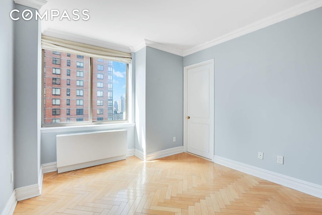 empty room with baseboards, ornamental molding, and radiator