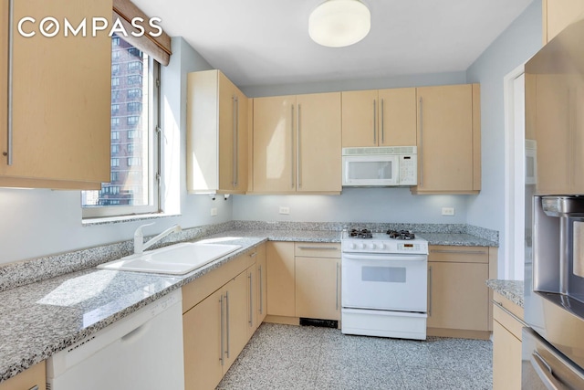 2 Columbus Ave Unit 17C, New York City, NY 10023 - kitchen featuring white appliances, light brown cabinets, a sink, and light stone countertops