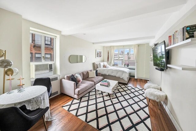 200 W 20th St Unit 1213, New York City, NY 10011 - bedroom featuring wood finished floors and beam ceiling
