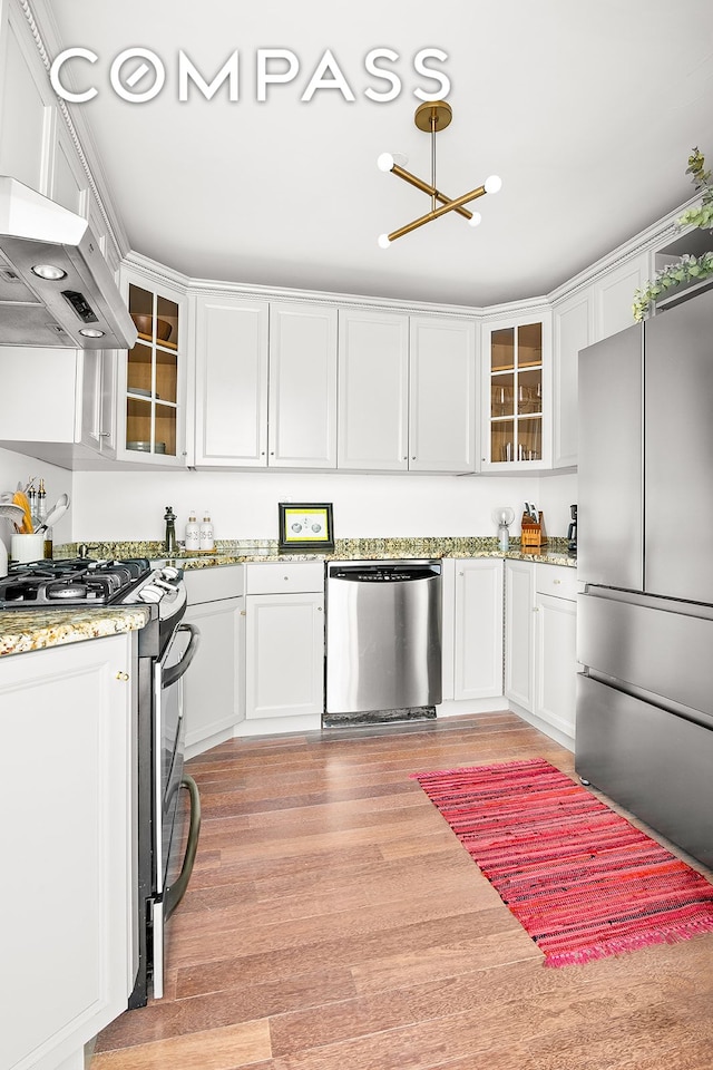 127 4th Pl Unit 2A, New York City, NY 11231 - kitchen with stainless steel appliances, white cabinetry, and range hood