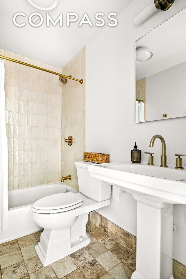 127 4th Pl Unit 2A, New York City, NY 11231 - bathroom featuring stone tile floors, shower / bathtub combination with curtain, and toilet