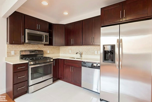 456 W 167th St Unit 7B, New York City, NY 10032 - kitchen featuring stainless steel appliances, a sink, light countertops, backsplash, and recessed lighting
