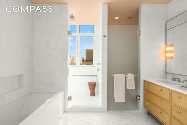 200 E 83rd St Unit 24C, New York City, NY 10028 - bathroom with a bath, a stall shower, and vanity