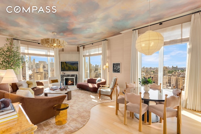 200 E 83rd St Unit 24C, New York City, NY 10028 - living room featuring a chandelier, wood finished floors, and a high end fireplace