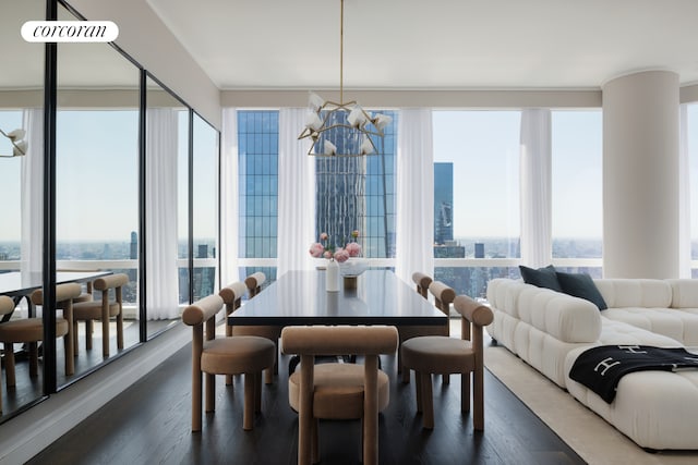 dining area featuring a city view, wood finished floors, and a notable chandelier