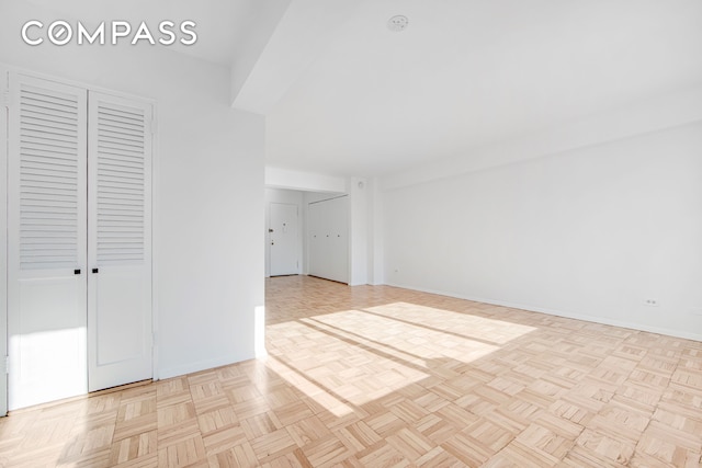 unfurnished room featuring baseboards