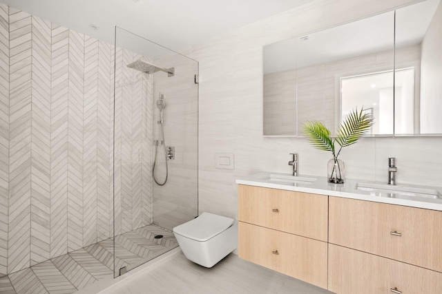 full bath featuring tile walls, tiled shower, double vanity, and toilet