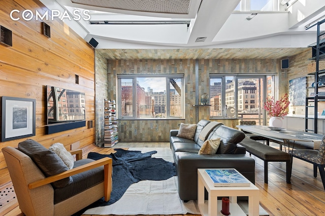 living room with wooden walls and hardwood / wood-style floors