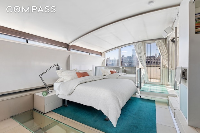tiled bedroom featuring a city view and lofted ceiling