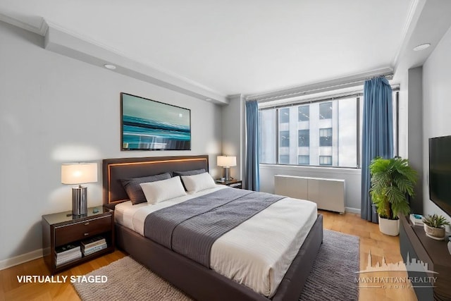 45 E 25th St Unit 11C, New York City, NY 10010 - bedroom featuring radiator, ornamental molding, baseboards, and wood finished floors