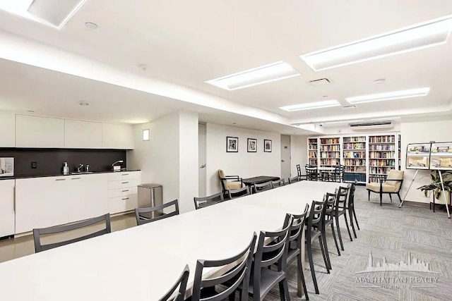 dining space featuring light colored carpet