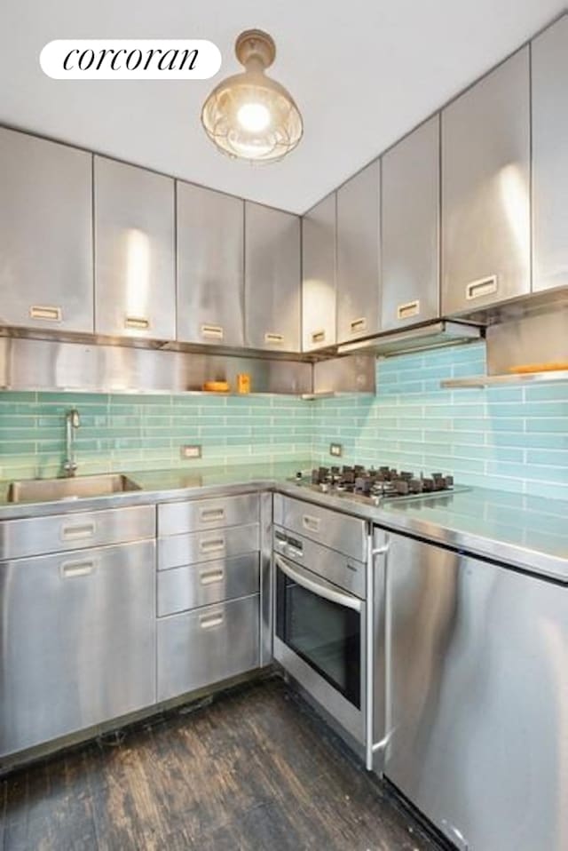 127 W 15th St Unit 4F, New York City, NY 10011 - kitchen with stainless steel counters, appliances with stainless steel finishes, a sink, dark wood-style floors, and gray cabinets