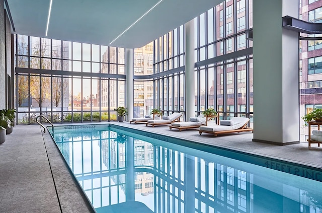 indoor community pool with a patio area