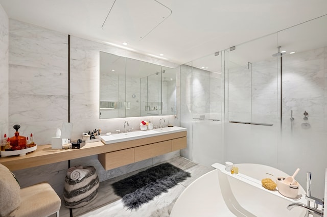 bathroom with a shower stall, a freestanding bath, tile walls, and double vanity