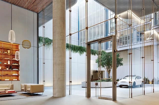 common area with a high ceiling and floor to ceiling windows