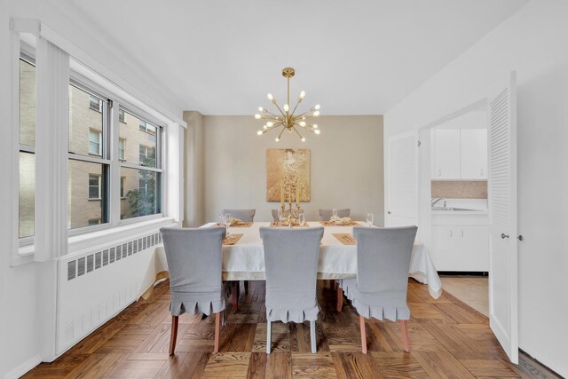 415 E 52nd St Unit 3Aa, New York City, NY 10022 - dining space featuring radiator and a chandelier